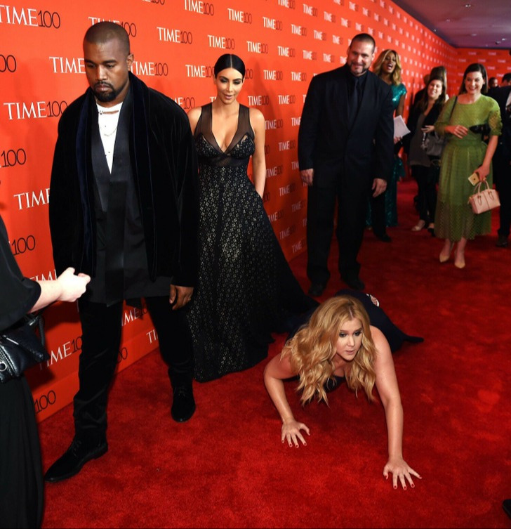 Fazendo graça, Amy Schumer foi ao chão no tapete vermelho, na frente de Kim Kardashian e Kanye West