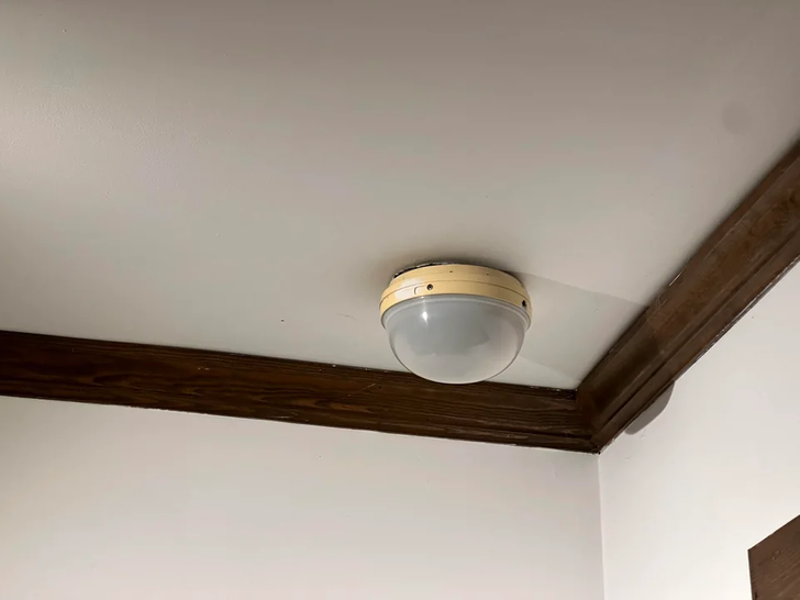 Round object with frosted glass hanging on the ceiling.